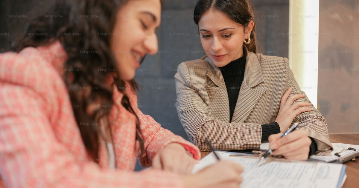 Business owner reviewing trademark registration documents with laptop showing UAE Ministry of Economy portal